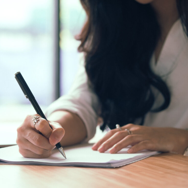 lady working at desk with notebook and planning