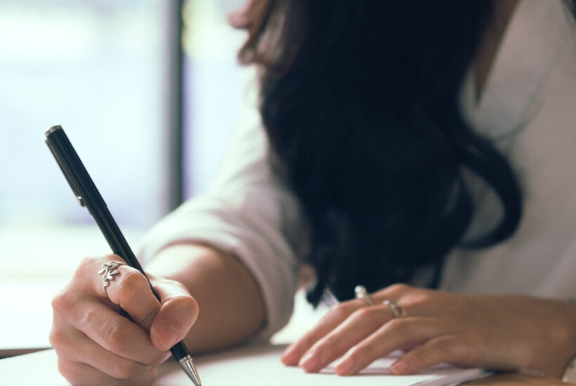 lady working at desk with notebook and planning