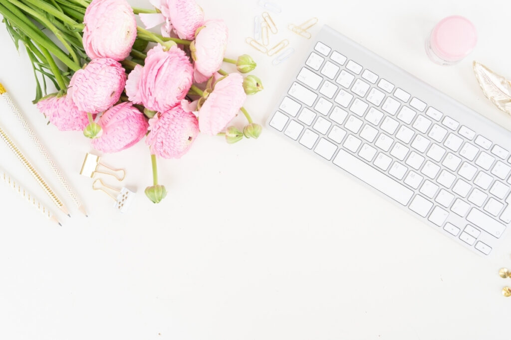 white computer keyboard with pink floral bouquet