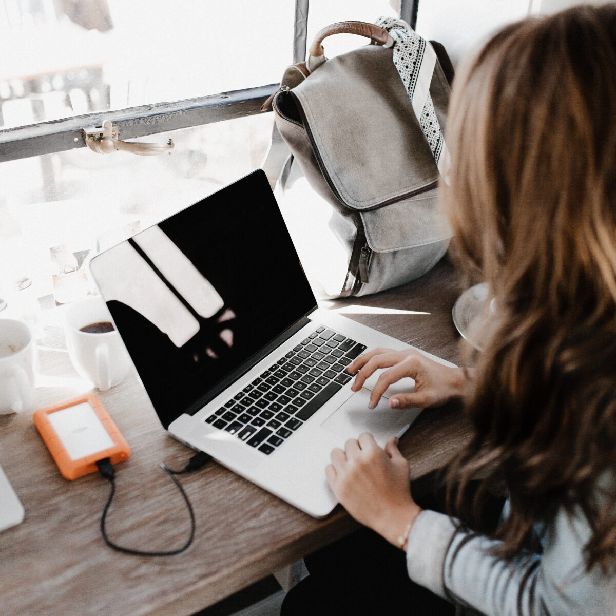 lady working on laptop by a window