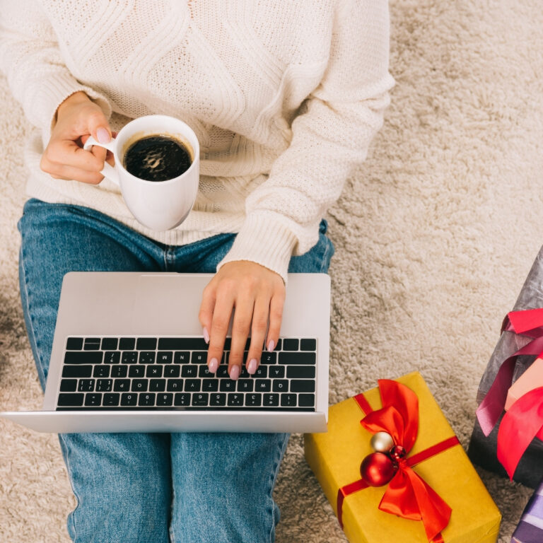 lady with laptop, cup of coffee and christmas gifts