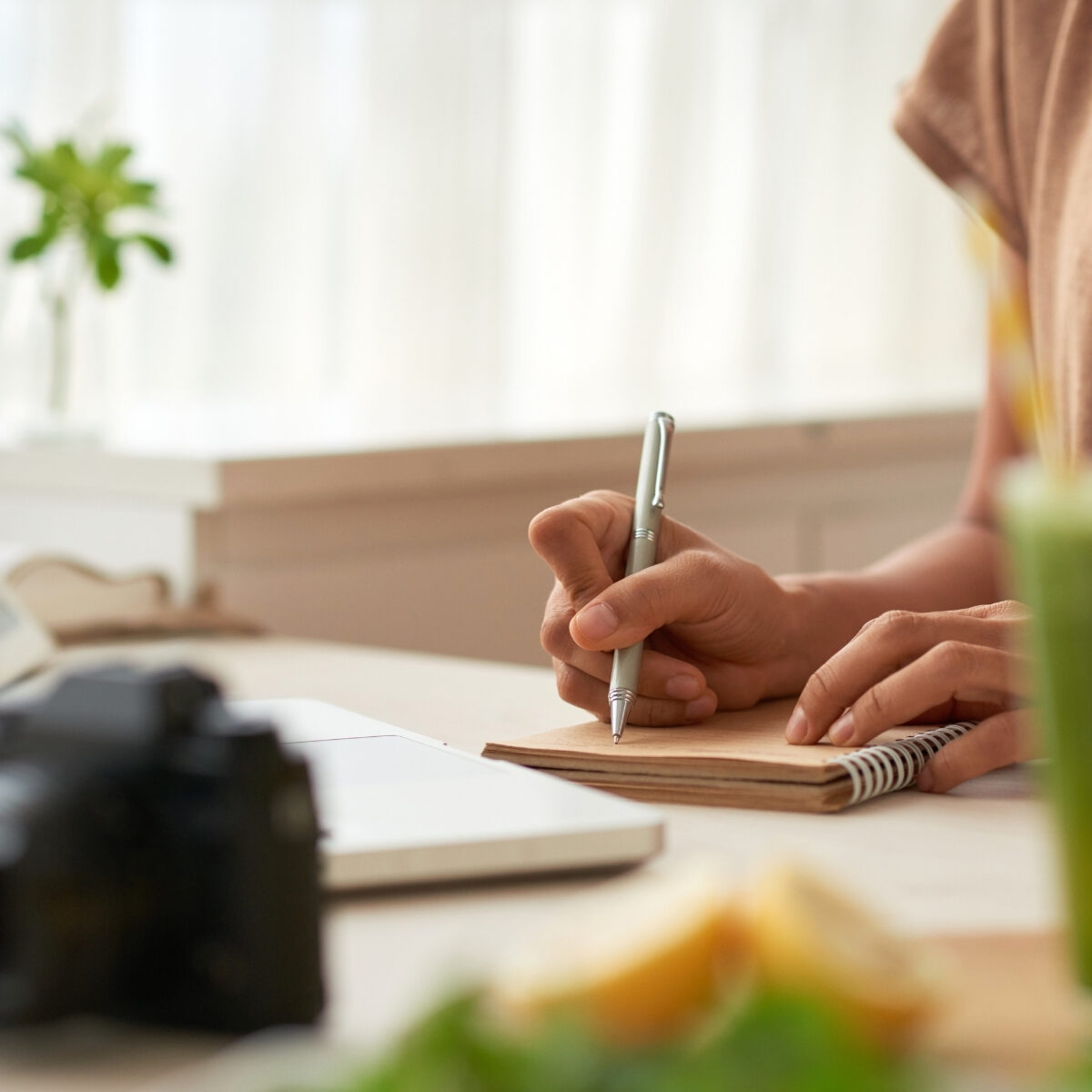 lady writing goals and tracking progress on notebook