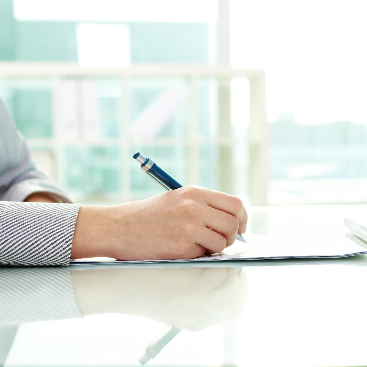 lady writing in a notebook at her desk 