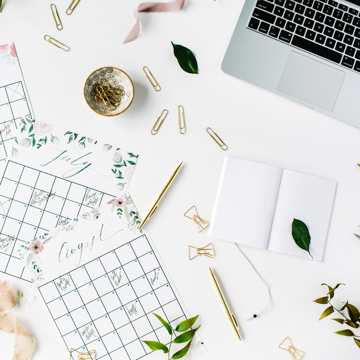 calendar pages and laptop on a desk 